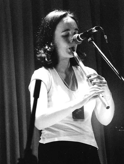 Claire Mann playing Low Whistle into a microphone