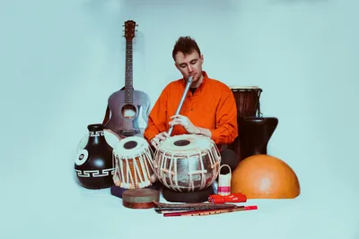 Ford Collier playing Low Whistle, surrounded by other instruments